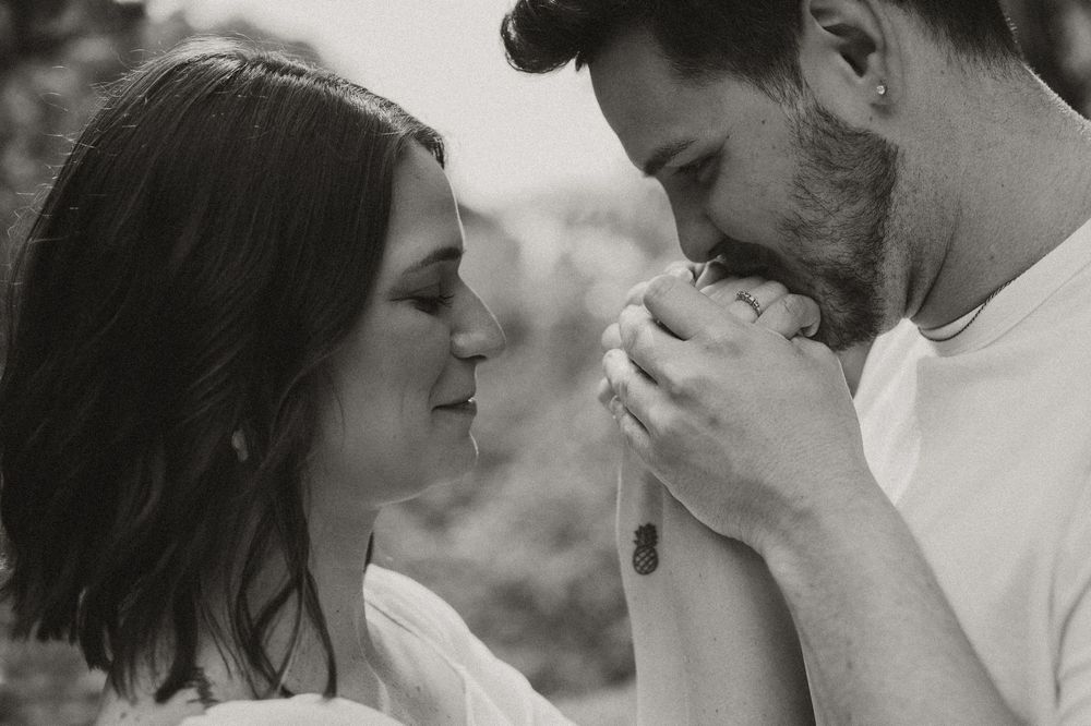 A romantic black and white collage showing intimate moments between a couple during a wedding photo session.