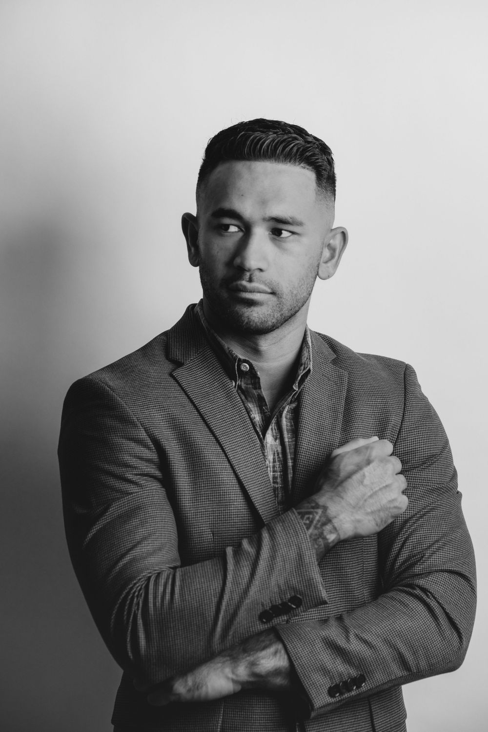 Black and white portrait of man in business attire with thoughtful expression.