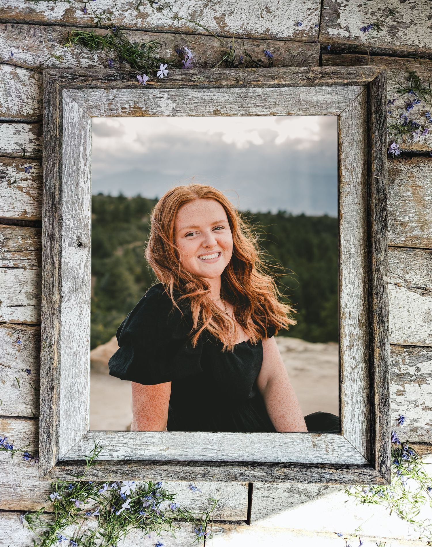 A rustic weathered white wooden frame displays a portrait photograph against a distressed wall background.