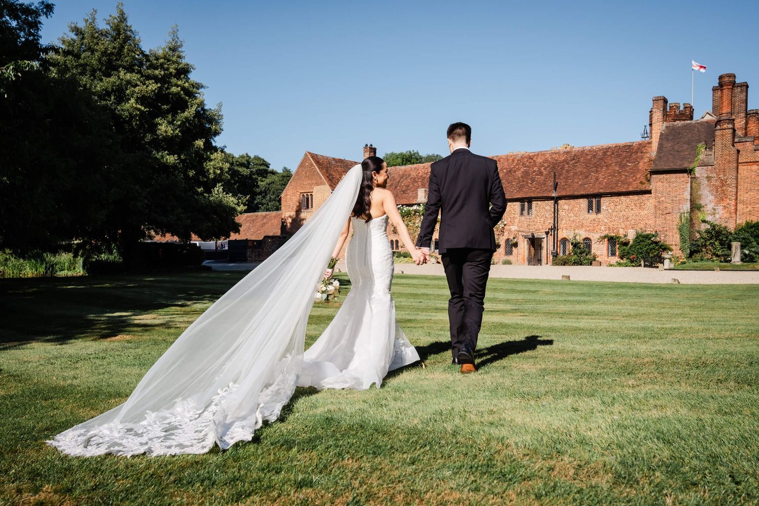Wedding in Kent bride and groom walking towards wedding reception