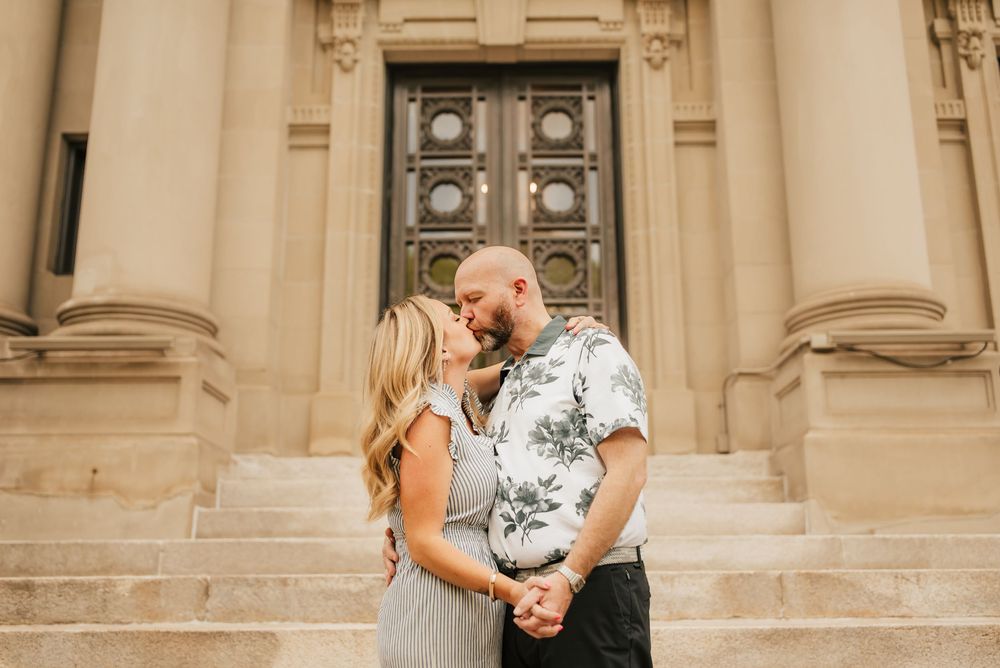 husband and wife kiss outside court house in downtown cincinnati