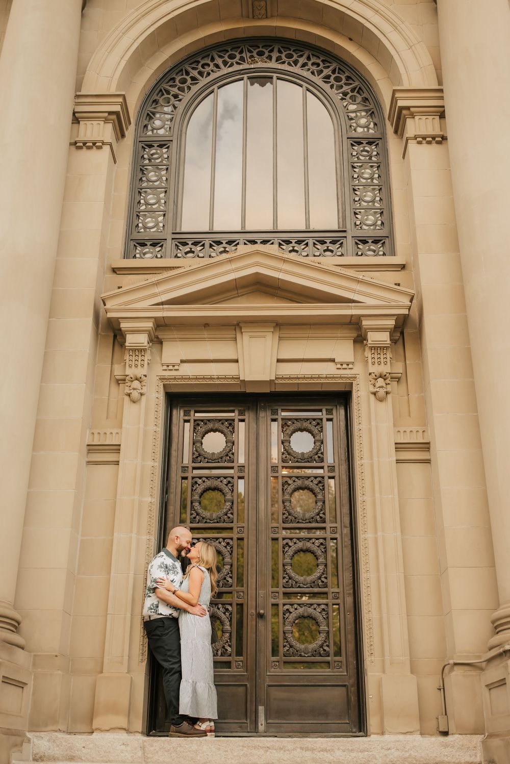 romantic couple kisses outside courthouse in downtown cincinnati