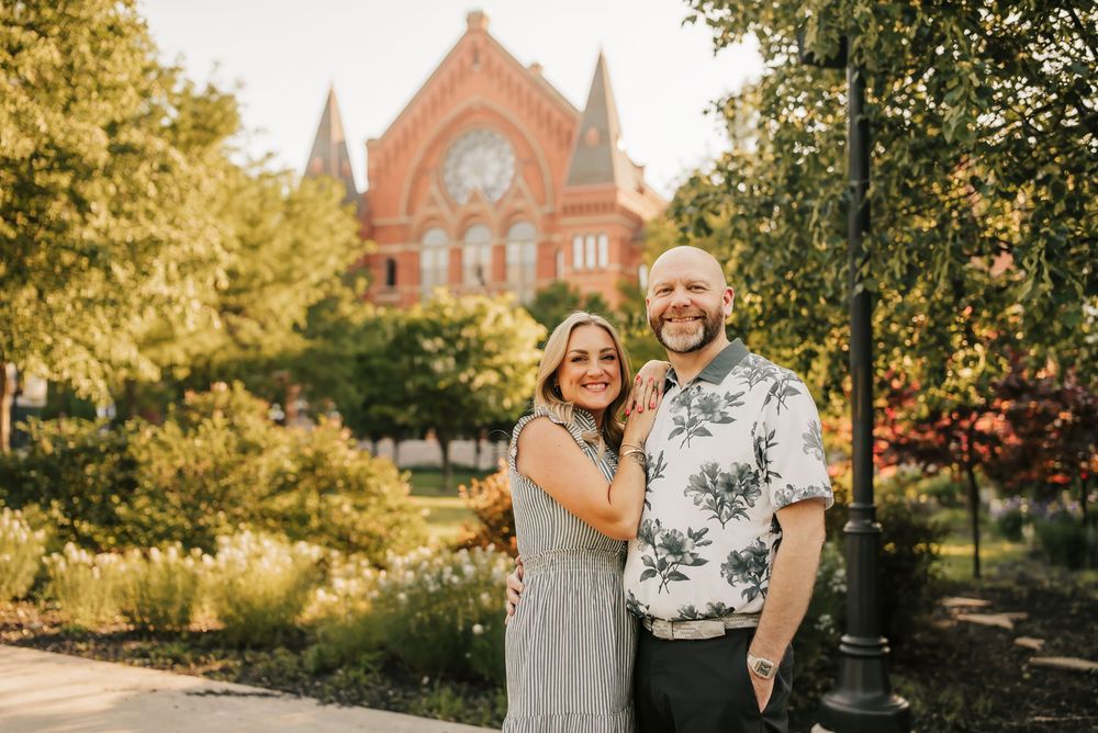 couple smiles for the camera in front of music hall in cincinnati, ohio