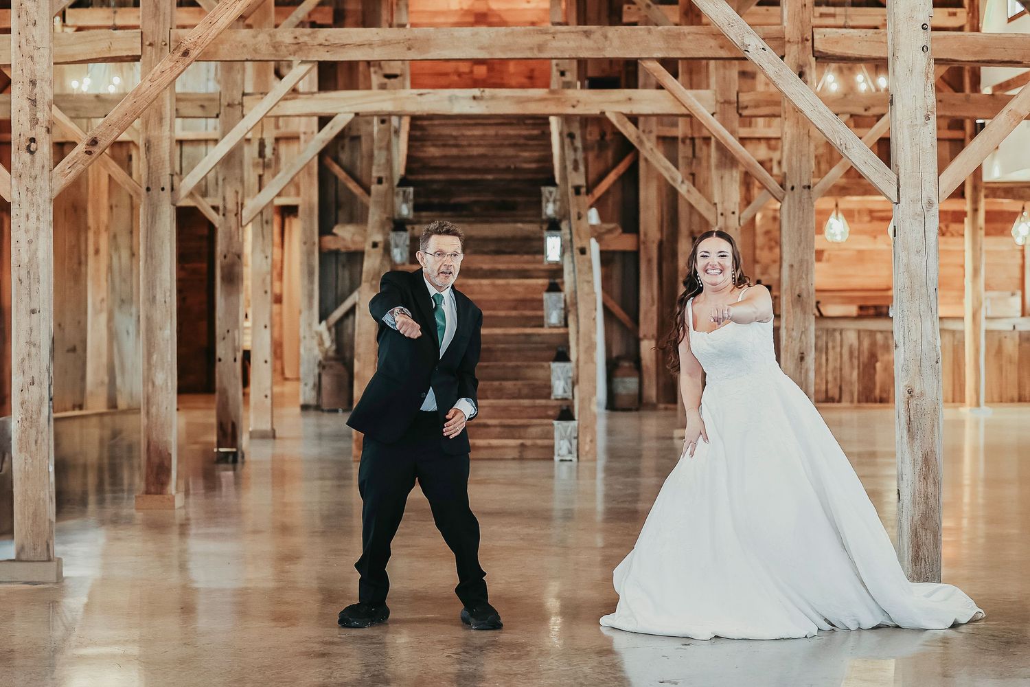 the father of the bride dances with his daughter for super fun daddy-daughter dance for her wedding celebration