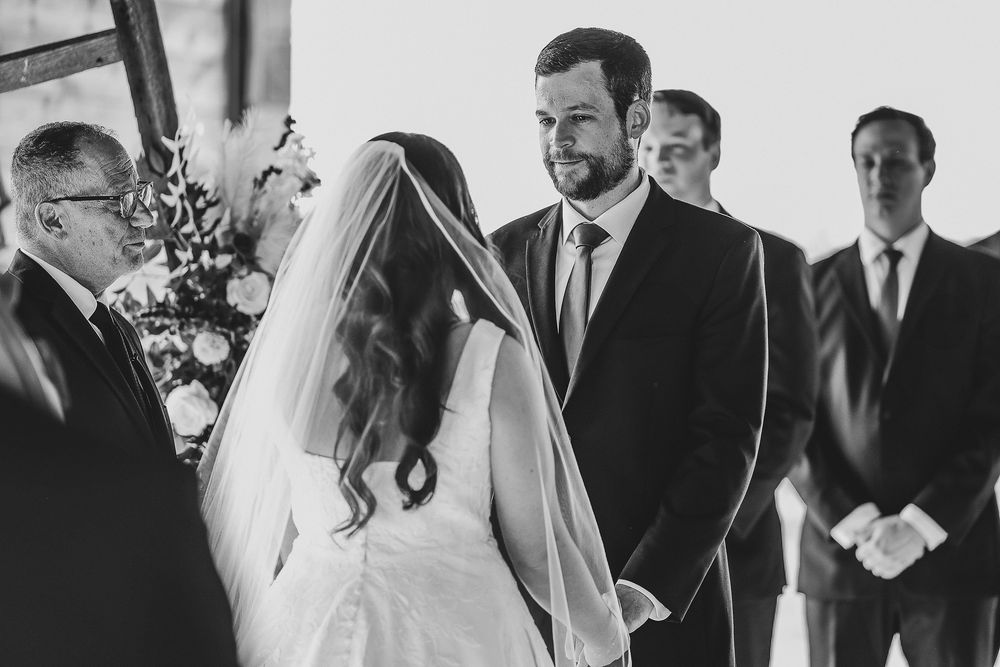Romantic wedding vows exchanged in open-air barn setting