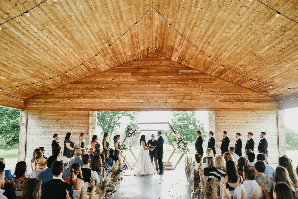 Wide-angle shot of The Madelyn barn pavilion during ceremony