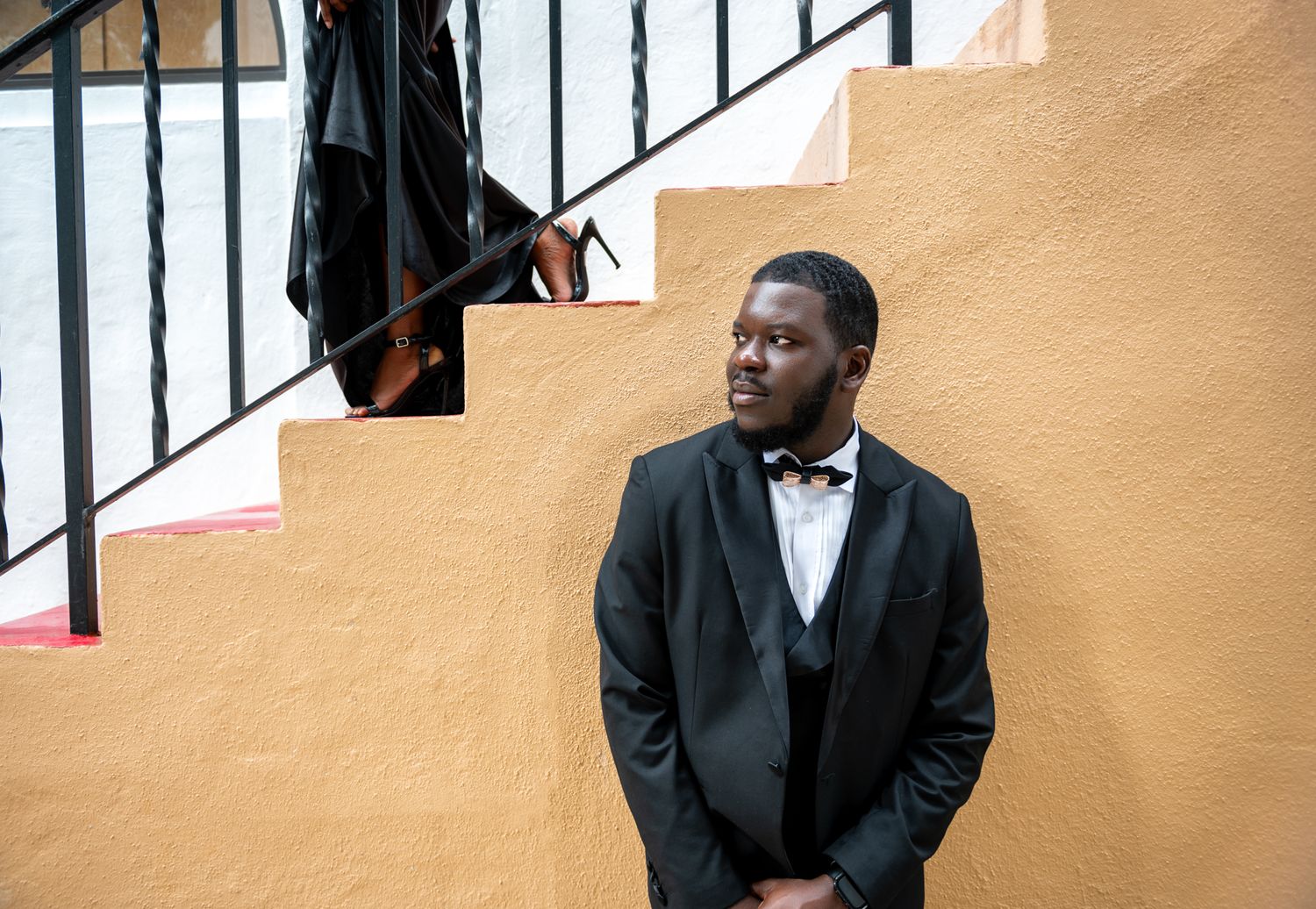 South Florida bride-to-be shows off her expensive shoes at her Palm Beach engagement session. Elegant black couple photography.