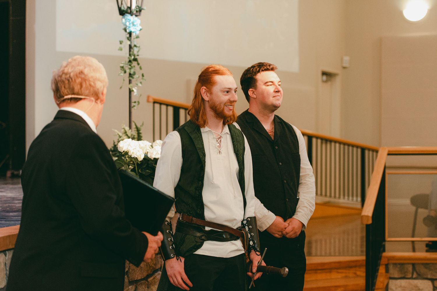 Groom awaits bride at the end of the aisle