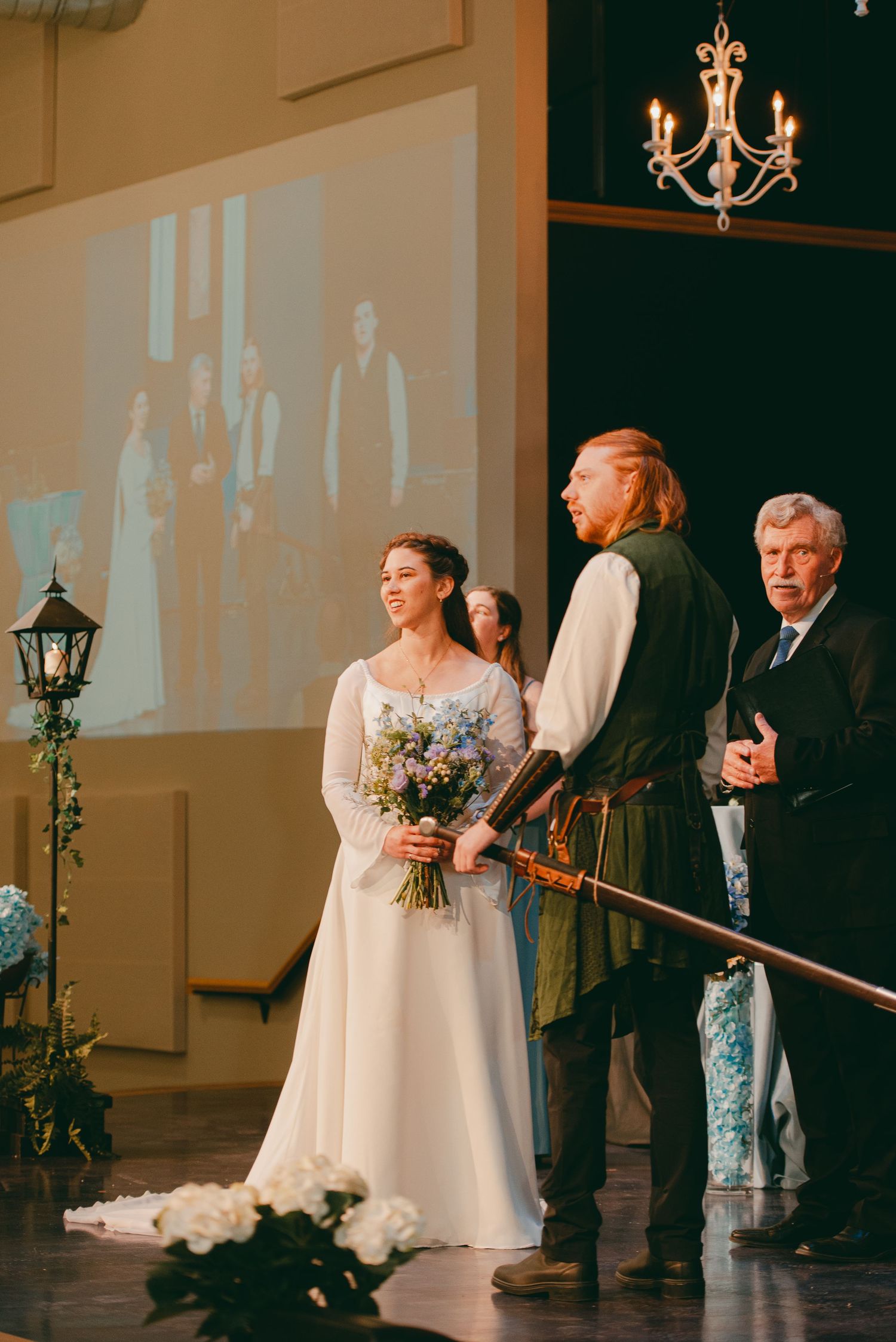 Bride and groom at ceremony overlooking the crowd of family and friends