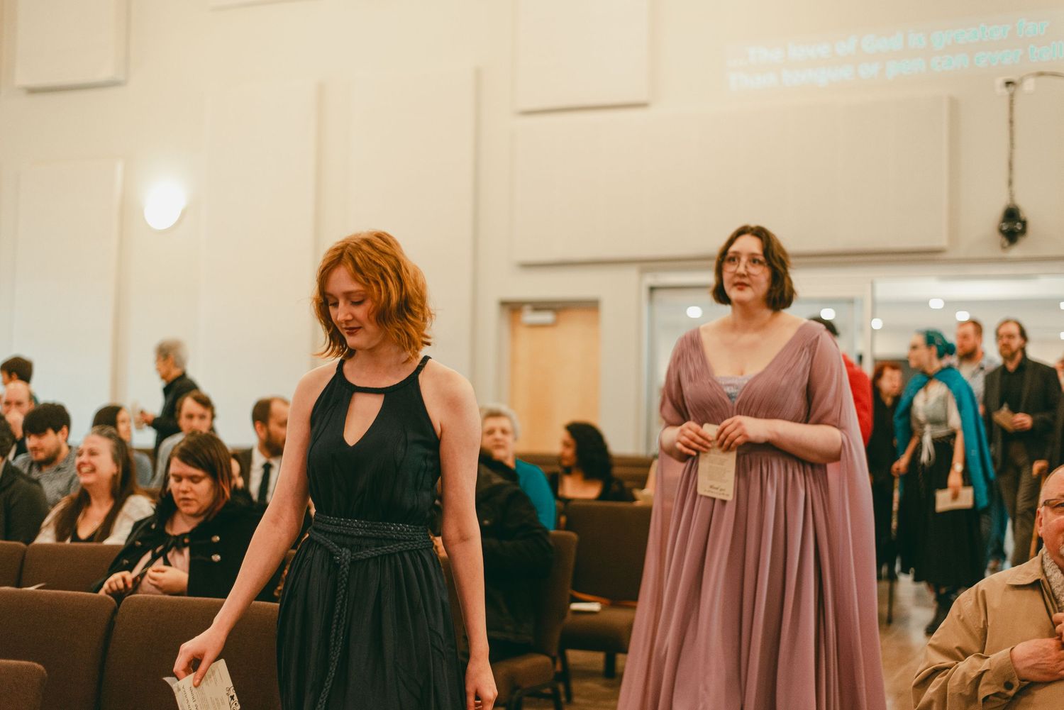 Sisters of groom walk down aisle