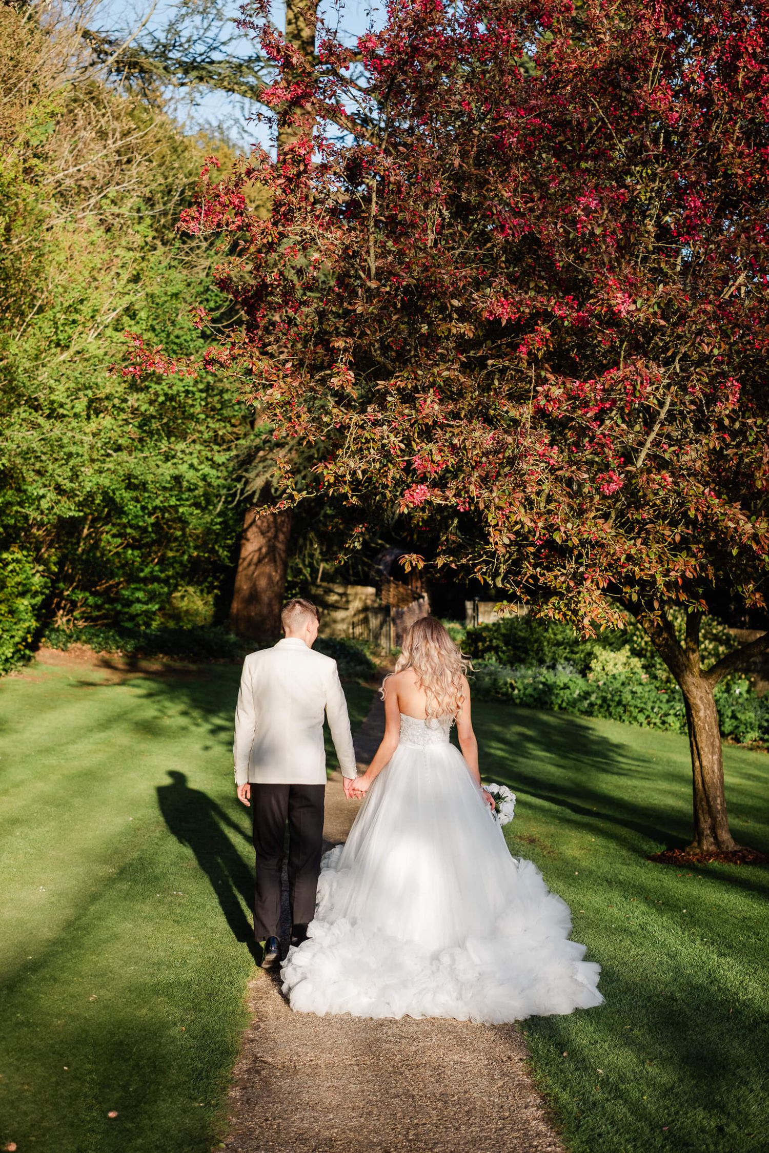 bride and groom walking in the sun at the orangery Kent
