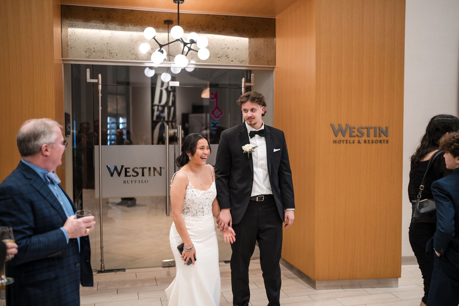 Wedding celebration at Westin Hotel with elegant decor and chandelier lighting.