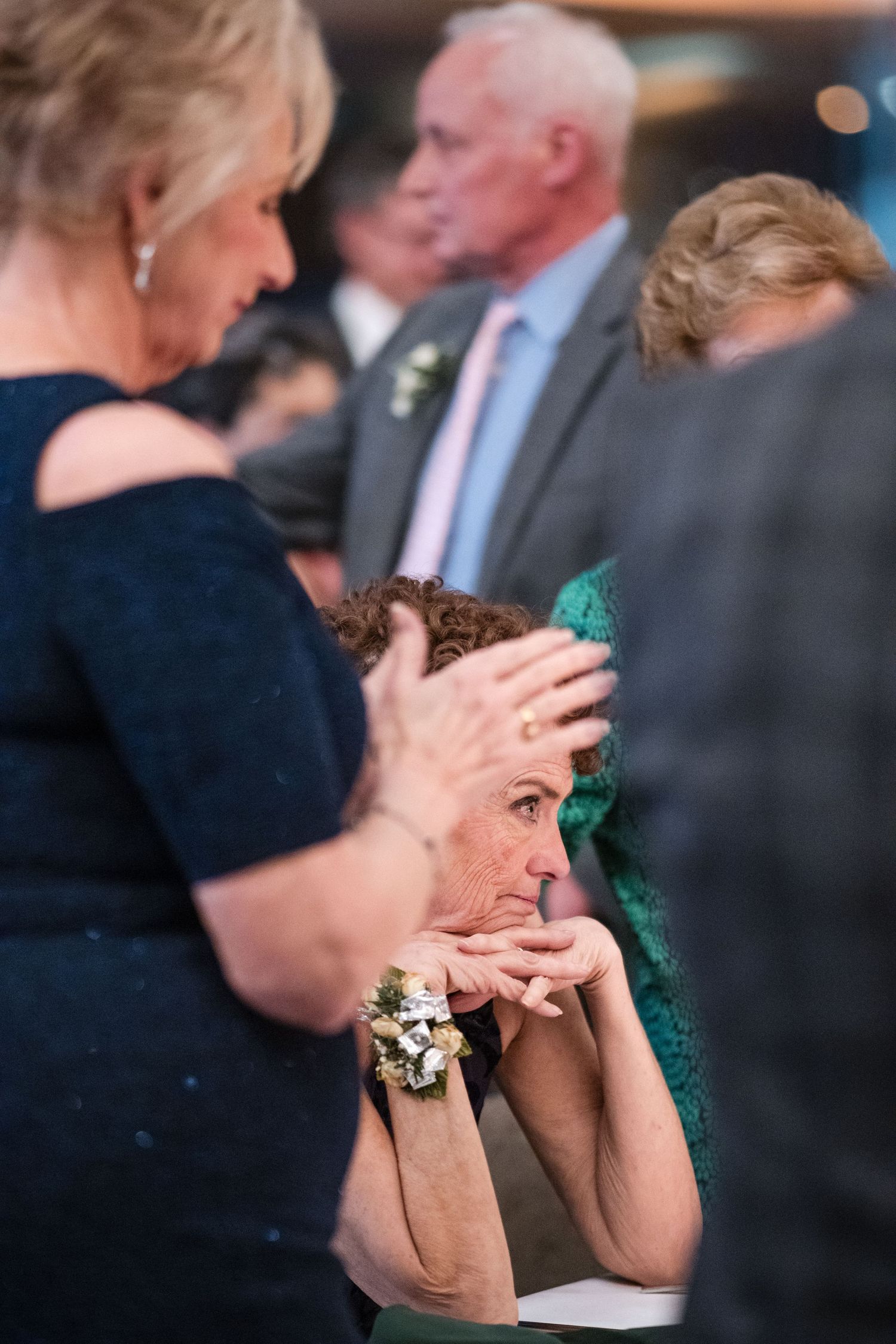 Wedding guests share an intimate moment during reception.
