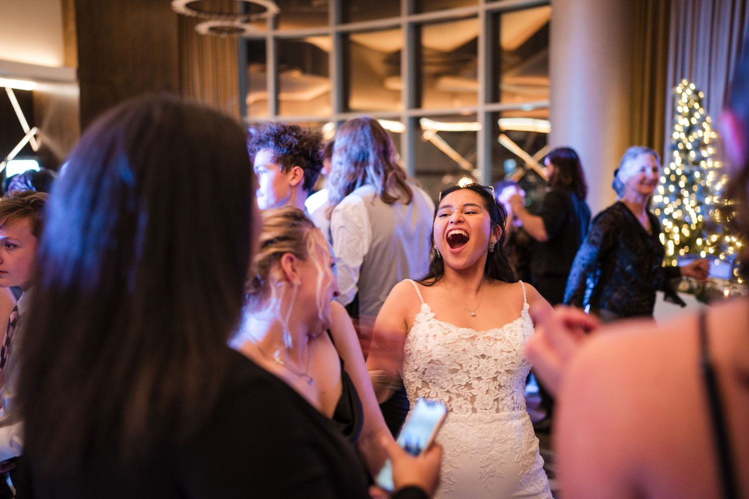 Energetic celebration with guests dancing at evening reception.