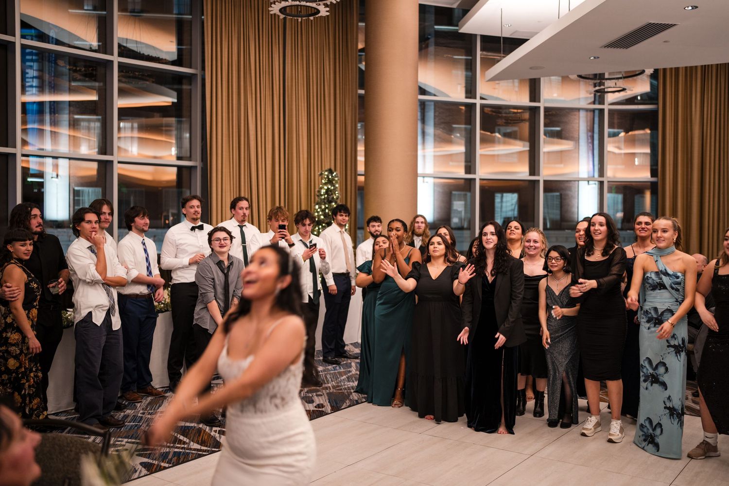 Wedding reception celebration with crowd gathered around dance floor.