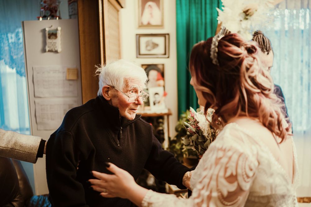 A romantic wedding sequence showing couple embracing in a rustic indoor setting with teal curtains.