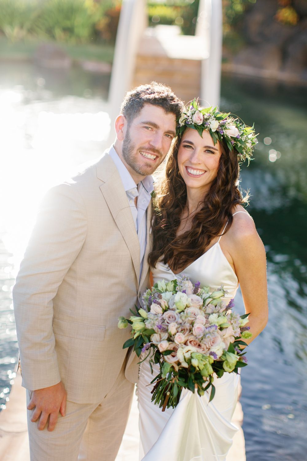 Wedding photoshoot at a beach setting with white florals and natural light.