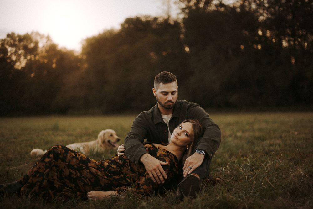 couple photographed with golden retriever dog in golden hour photoshoot in Huntsville Alabama