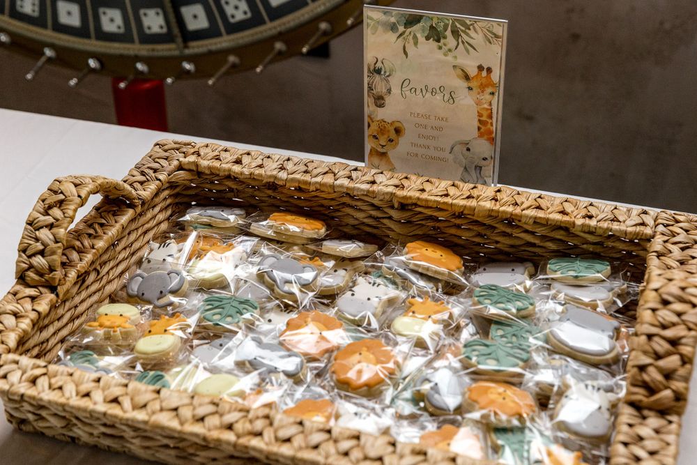 Decorative cookies displayed in a woven basket at a themed party.