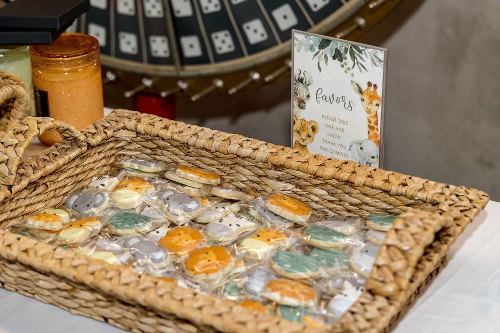 Party favors and treats arranged in woven basket with decorative cards.
