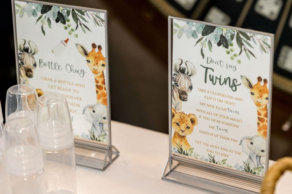 Safari-themed party signs in glass frames featuring cute animal illustrations.