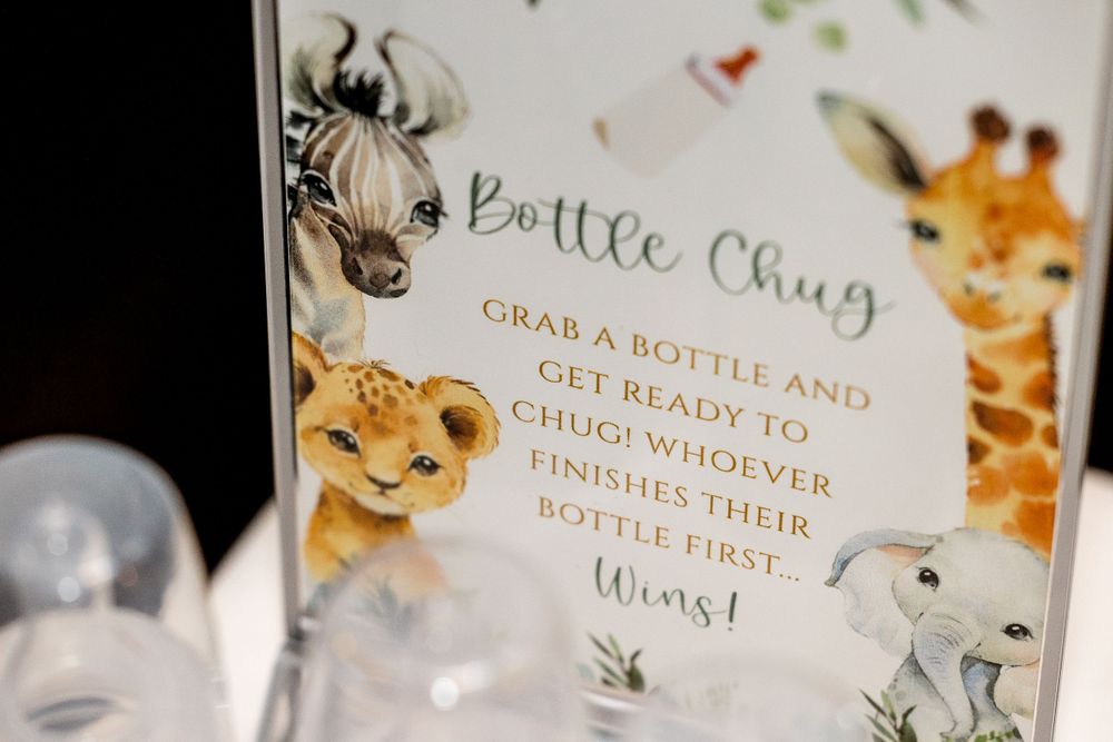 Safari-themed party game sign featuring cartoon animals and drinking instructions.