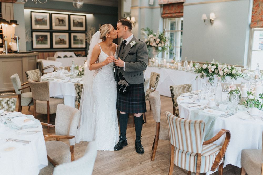 Wedding reception venue decorated with elegant white linens and floral centrepieces at Washingborough Hall - taken by Grimsby photographer.