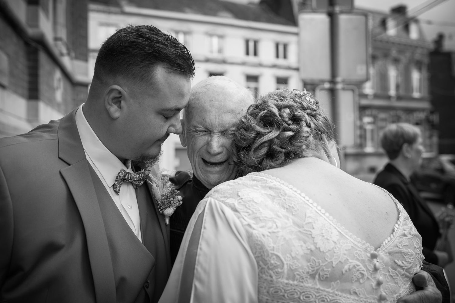 A black and white collage of candid wedding moments showing the couple in romantic poses during their special day.