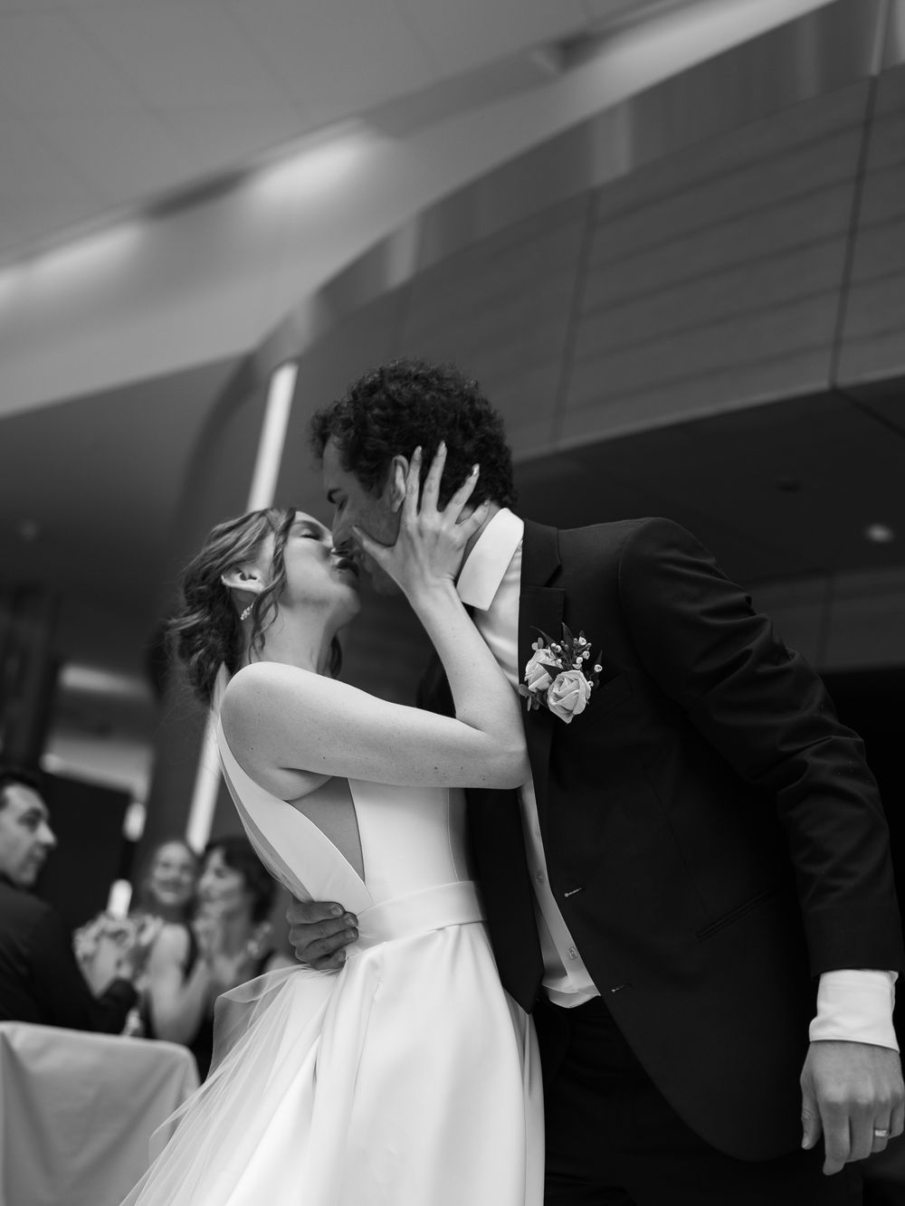 A romantic moment captured in black and white as a couple shares their first dance at a wedding reception.