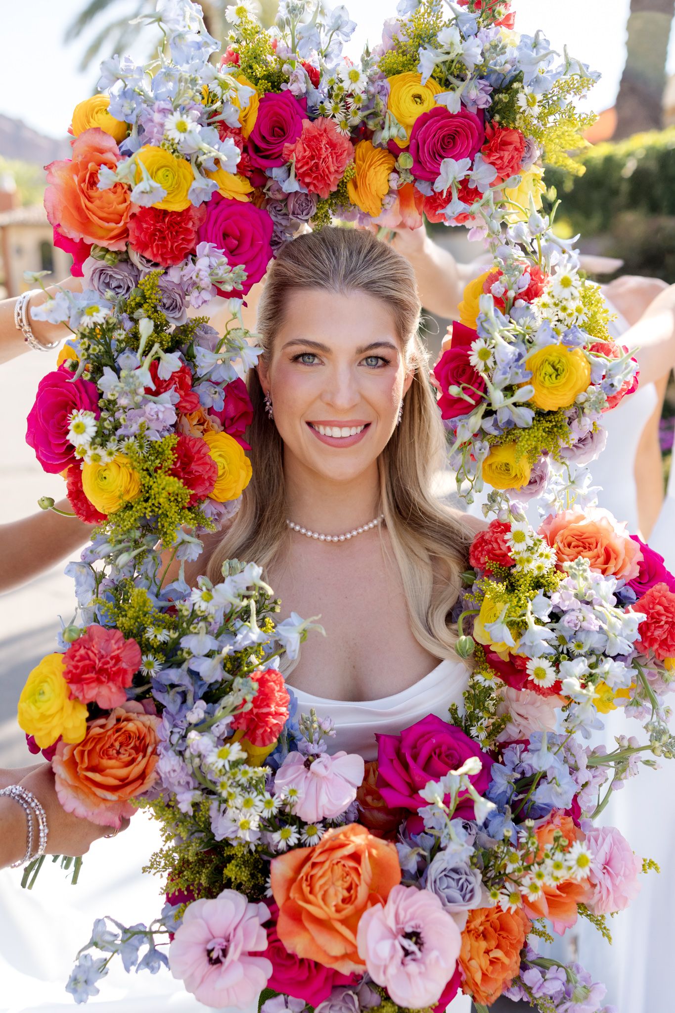 Vibrant floral crown with colorful roses, daisies and wildflowers arranged in a stunning circular display.