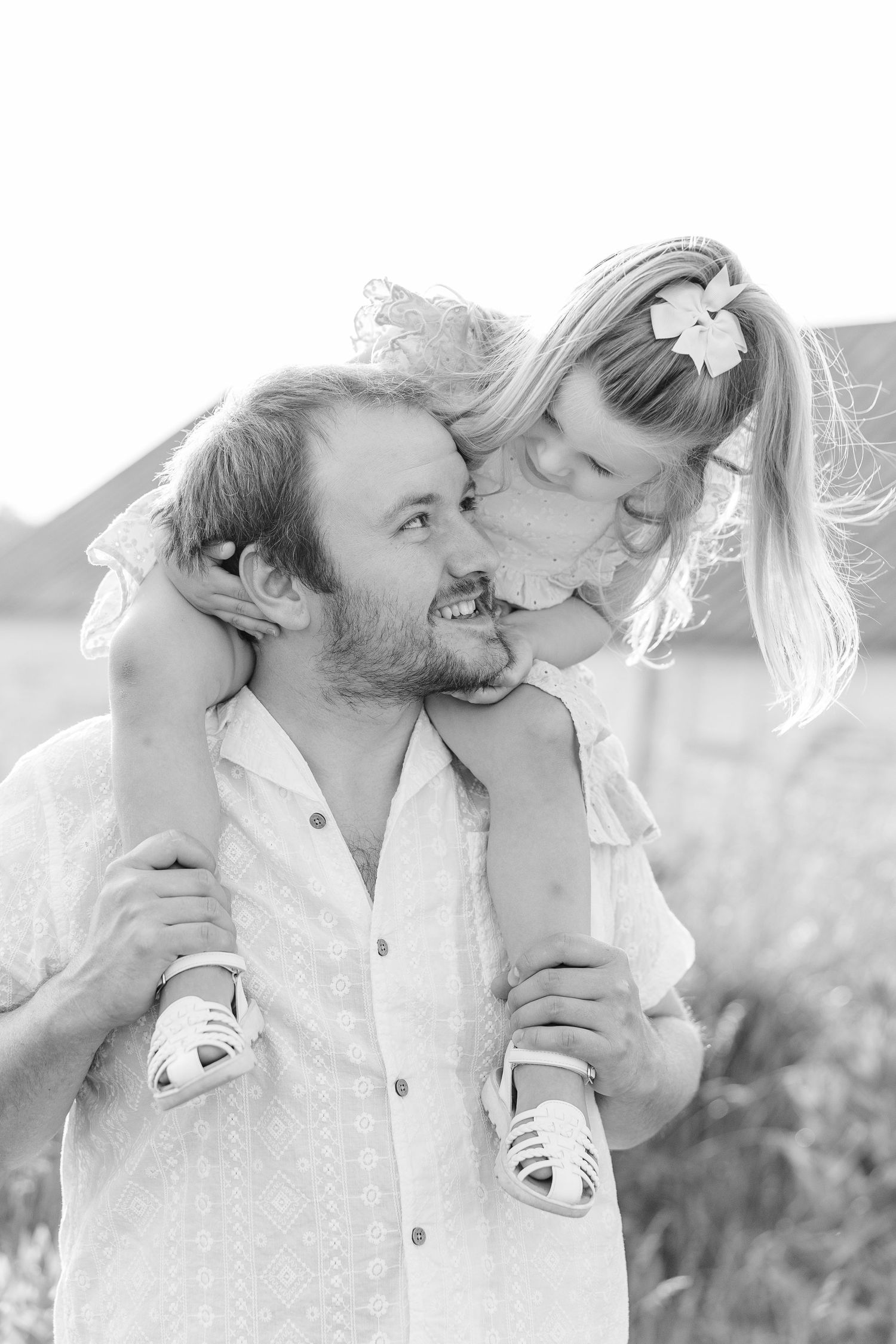 Romantic black and white close-up photography showcasing tender intimate moments between a couple outdoors.