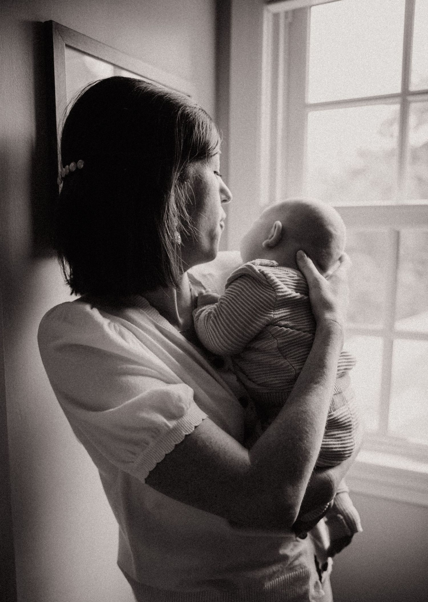 A black and white photo sequence shows two people embracing near a window in progressive tender moments.