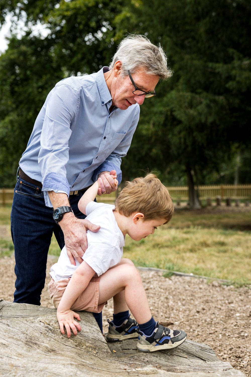grandad helping grandson climb
