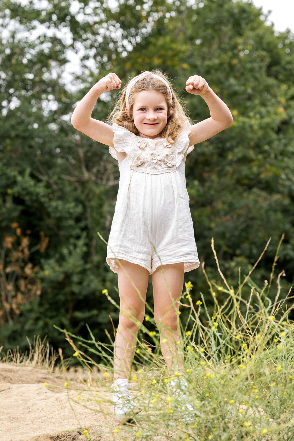 young girl climbing to the top of a hill