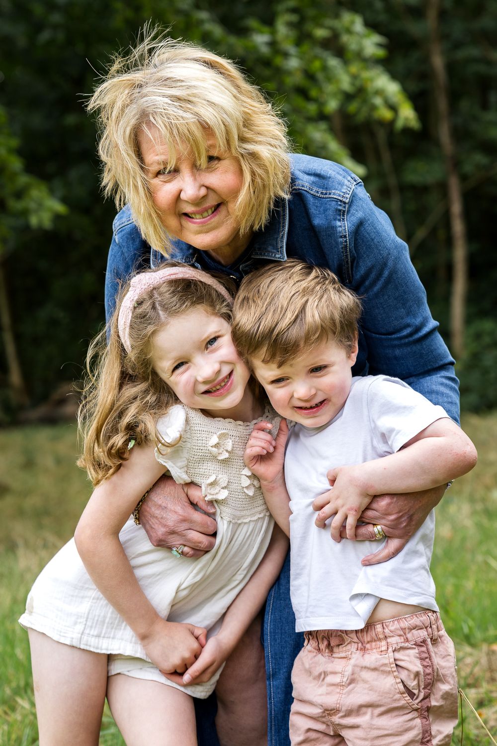 grandmother hugging her two grandchildren