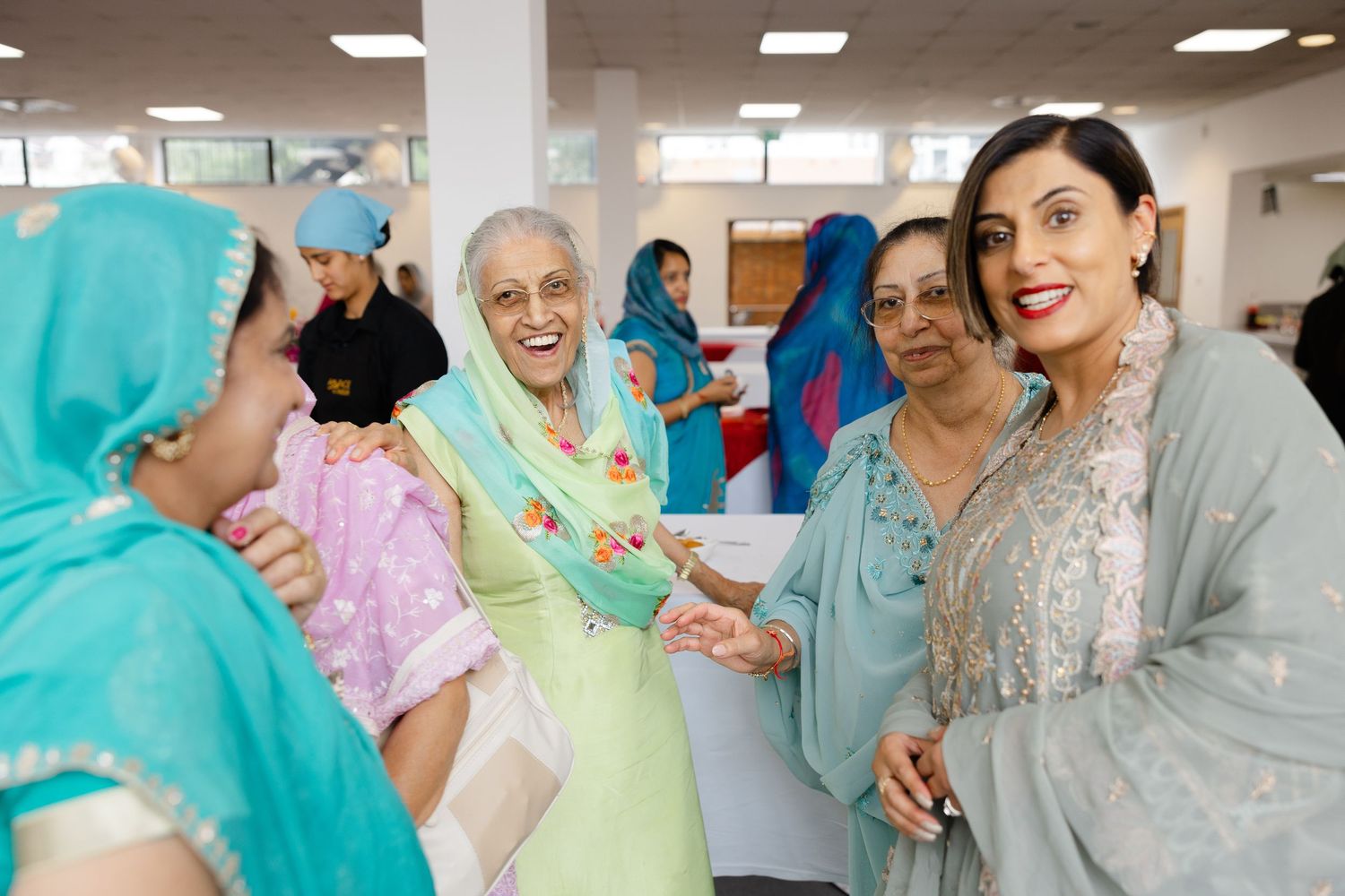 Candid moment of happy guests at wedding in Hounslow Gurdwara