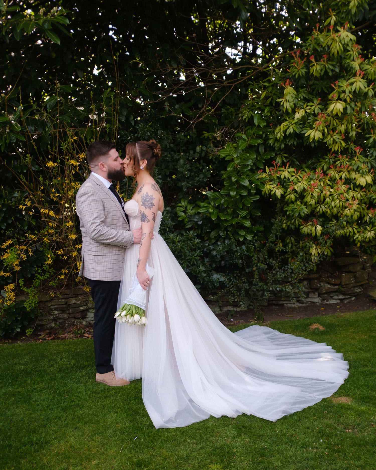 Alice and George sharing a kiss in the grounds of Holdsworth House, Halifax