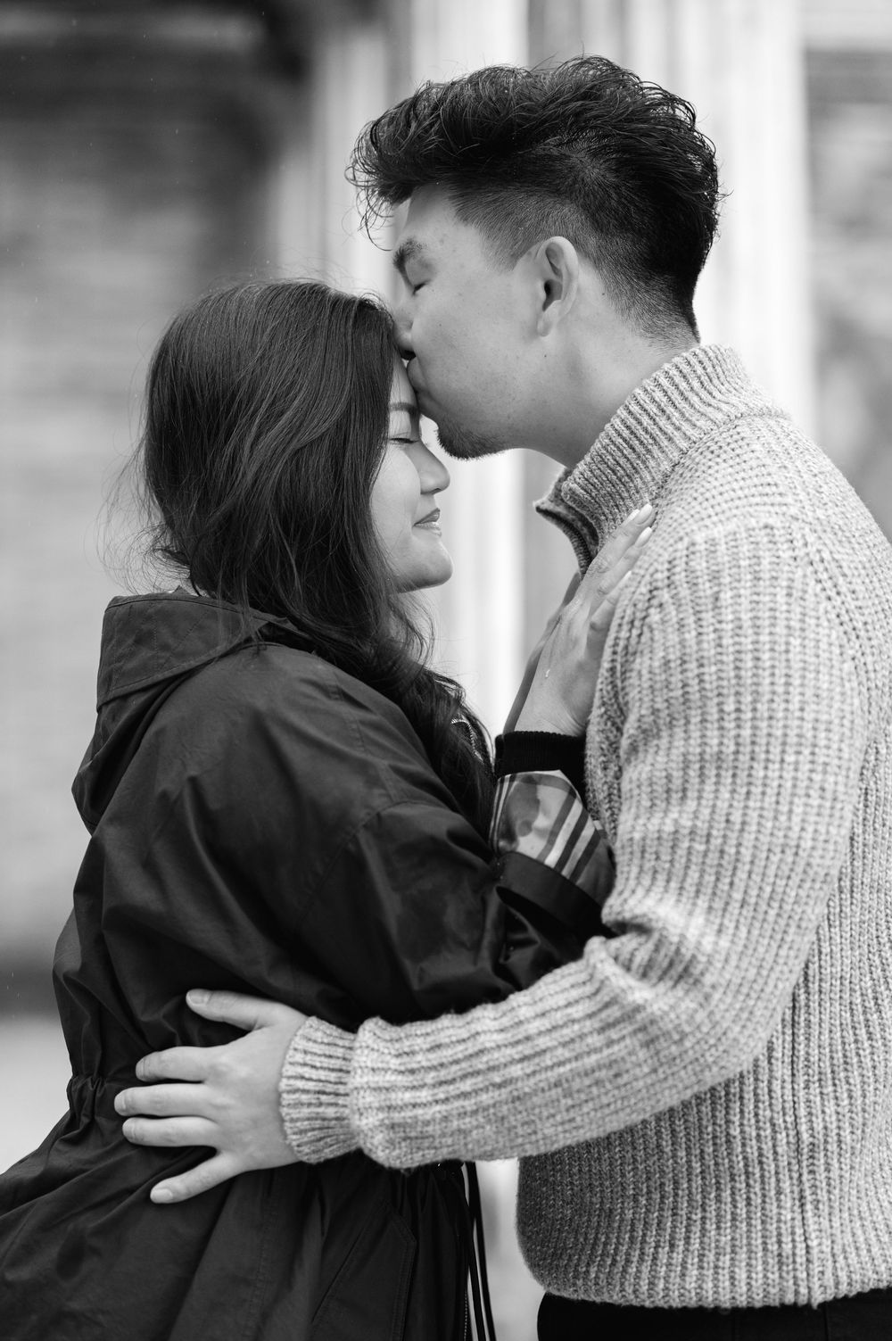 A black and white portrait of a couple sharing an intimate moment in soft lighting at Untermyer Gardens in Westchester, NY