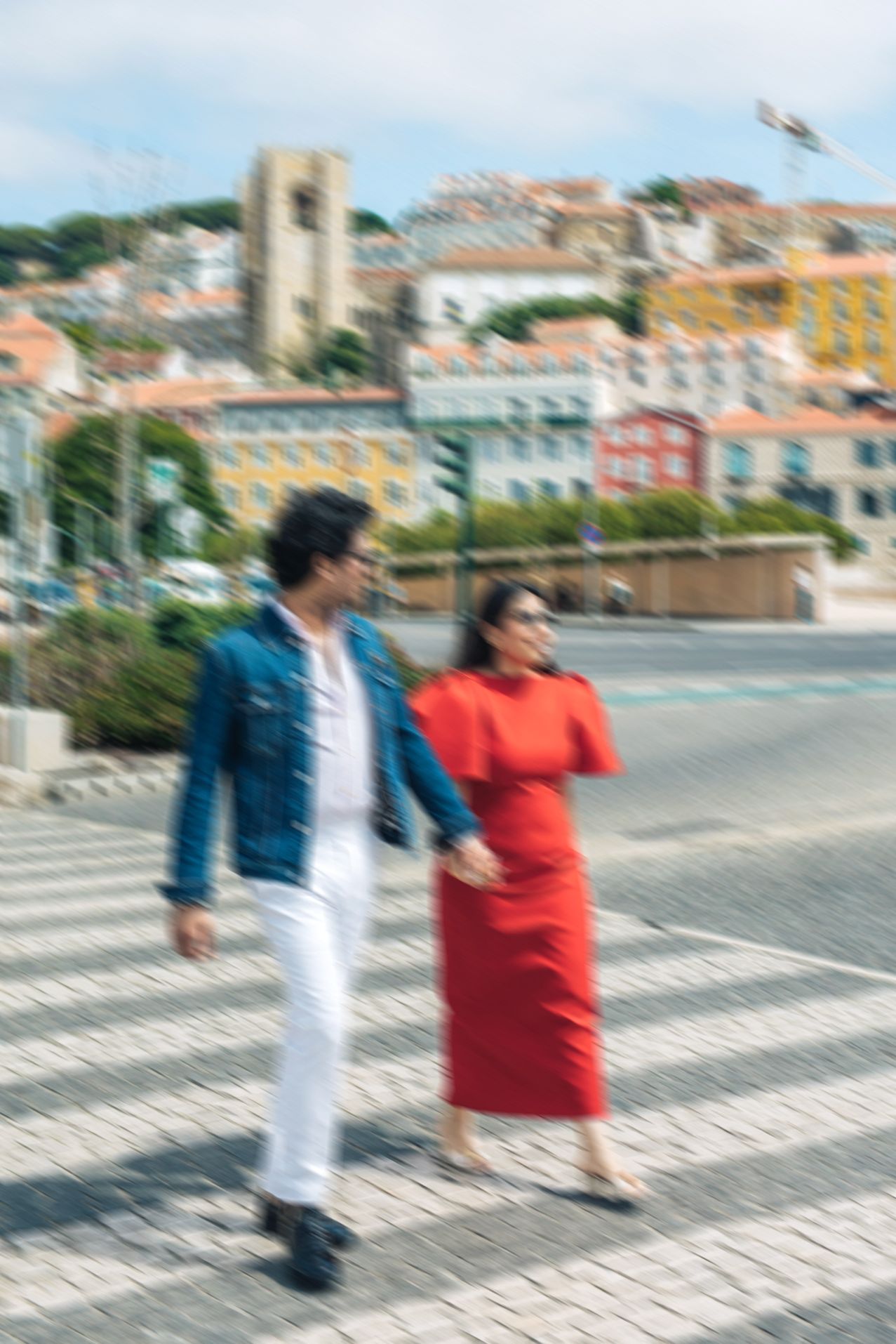 Indian couple walking through the streets of Baixa, Lisbon during their engagement session.