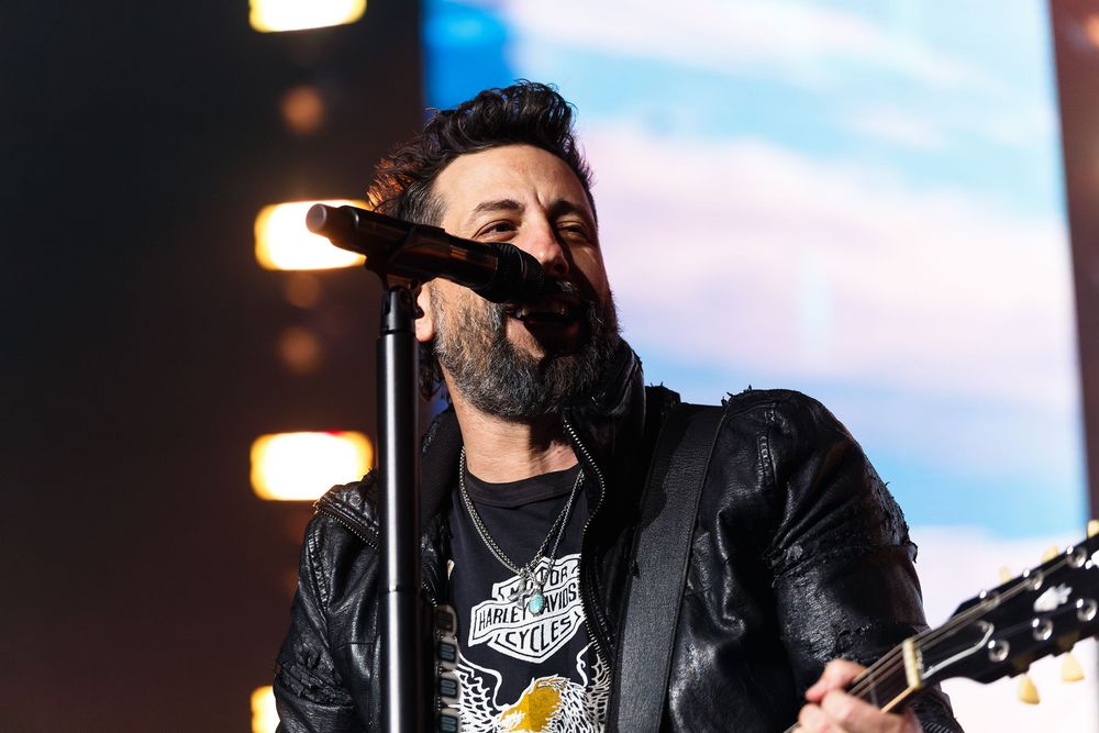 Country musician Matthew Ramsey of Old Dominionperforming with electric guitar on stage under concert lighting at Bridgestone Arena.