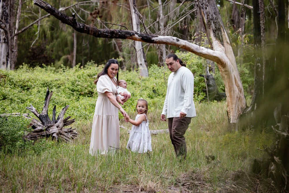 A family shares a tender moment together in a natural woodland setting.
KAPOLEI PHOTO SESSION