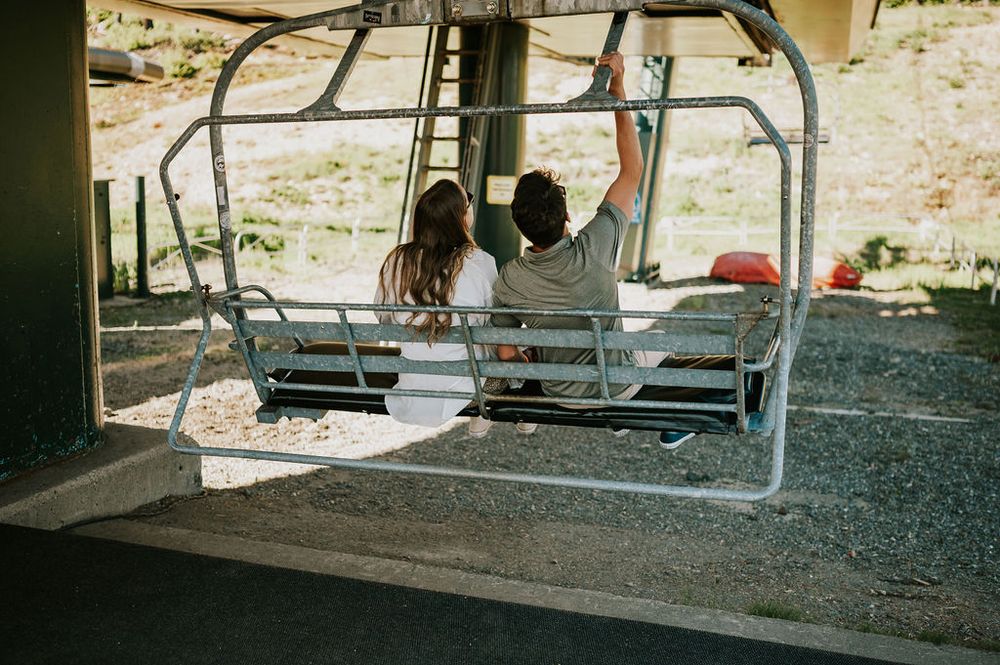 Couple photoshoot boarding scenic chairlift Mt Washington. Photography by Photographer Soulfull Photographs