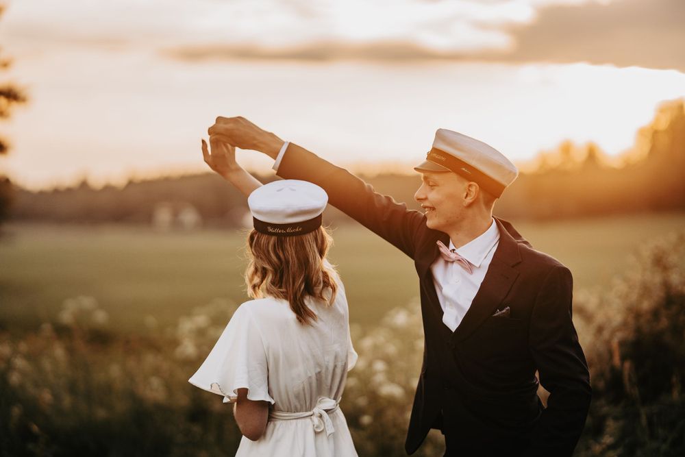 A romantic dance pose captured during golden hour in a rustic outdoor setting.