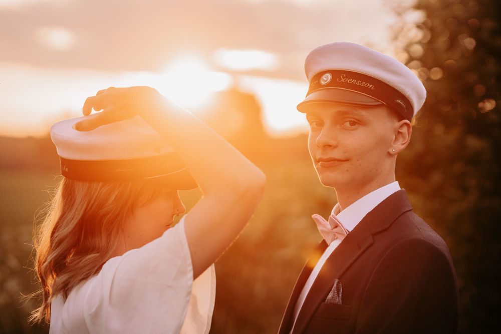 A sunset photoshoot featuring vintage-inspired white and black formal attire.