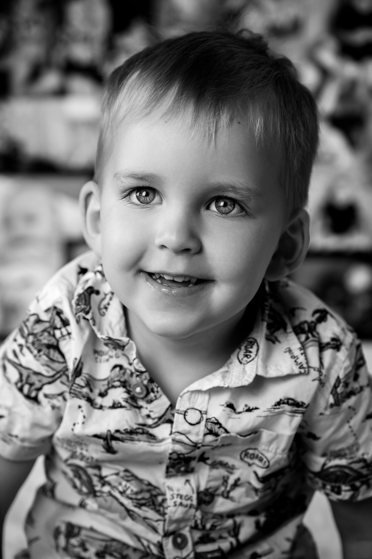 Black and white portrait showcasing bright eyes and a patterned shirt.