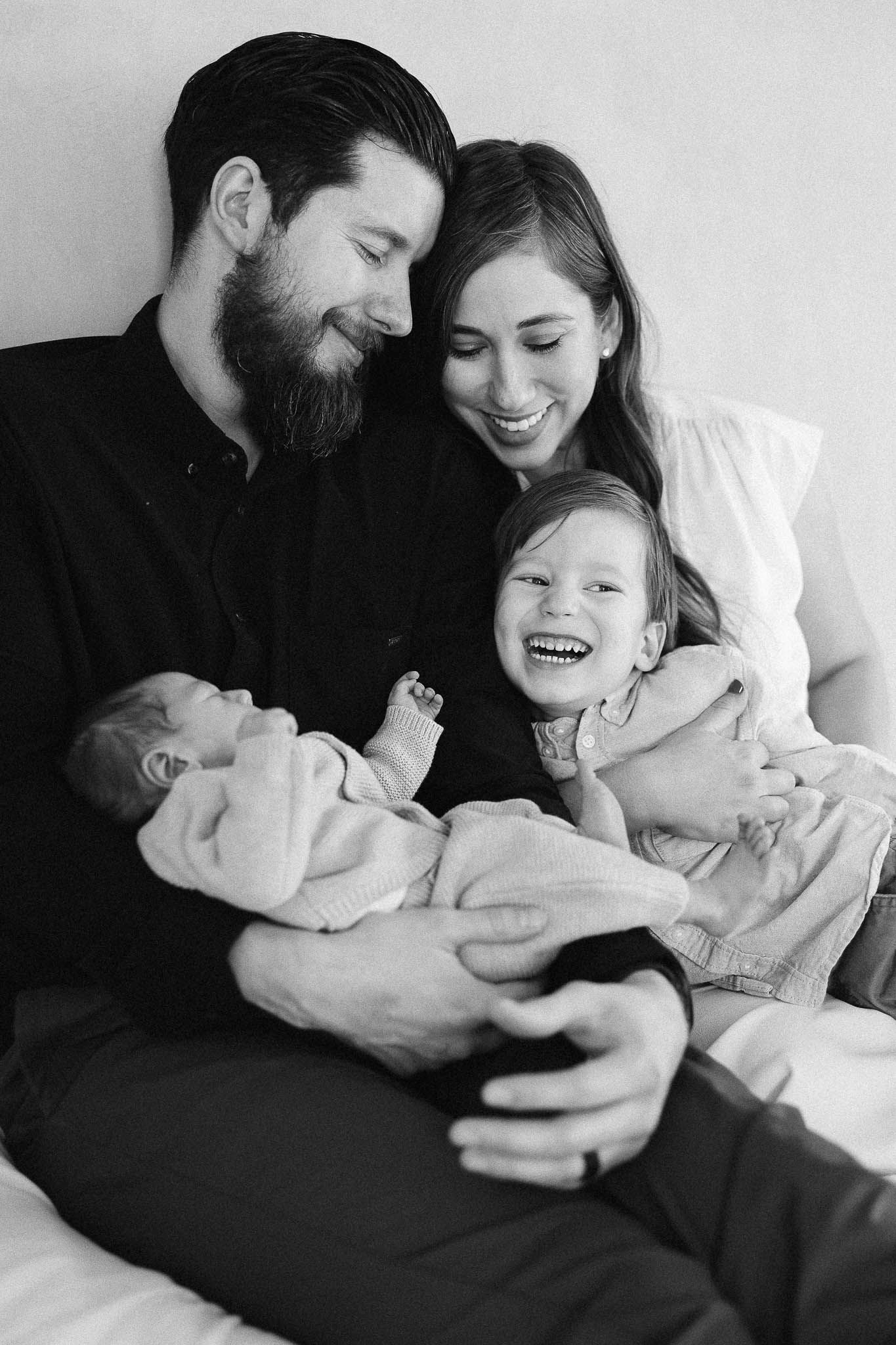 Black and white intimate family lifestyle photos showing tender moments of laughter and connection.