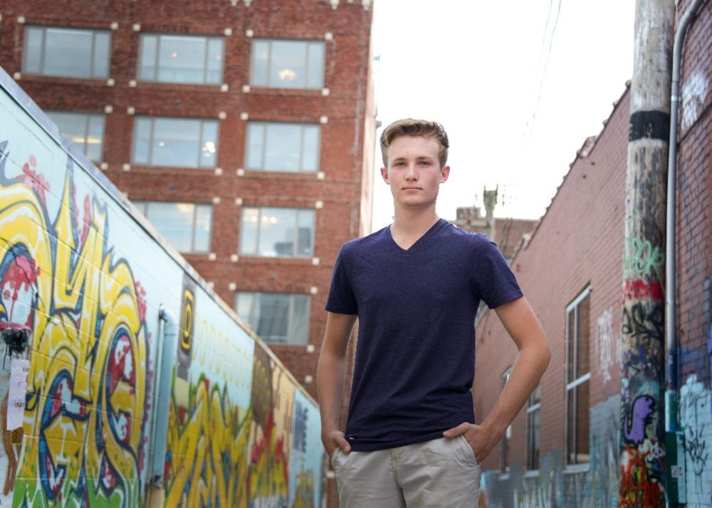 Urban street art setting with colorful graffiti wall and casual navy t-shirt.