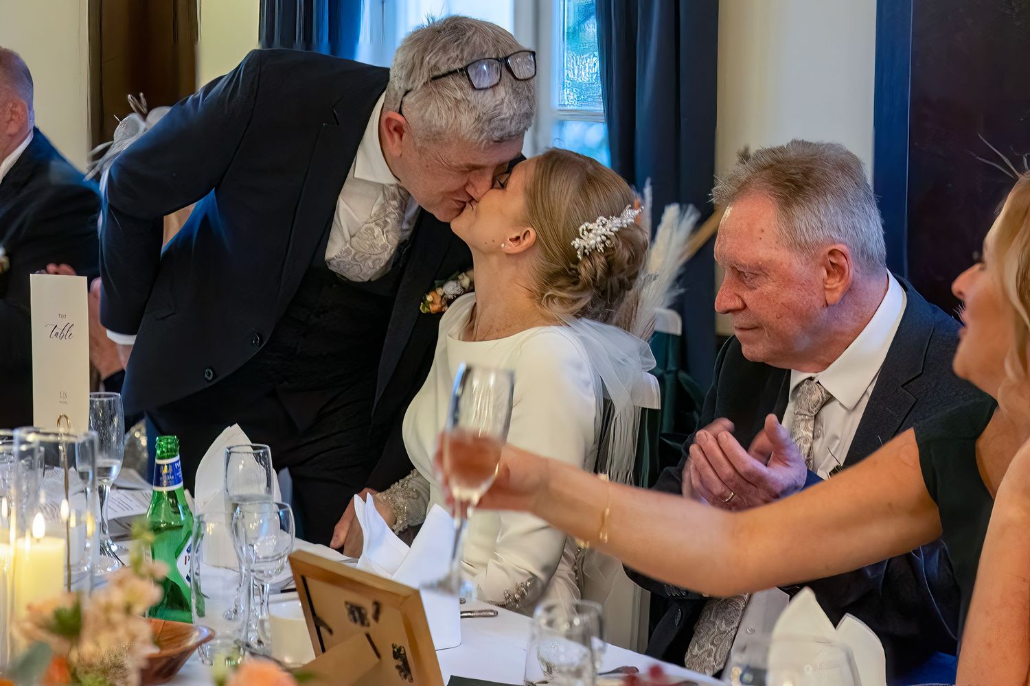 groom gives the bride a kiss during the wedding speeches. Stuart Morris the atheneum liverpool wedding photographer.