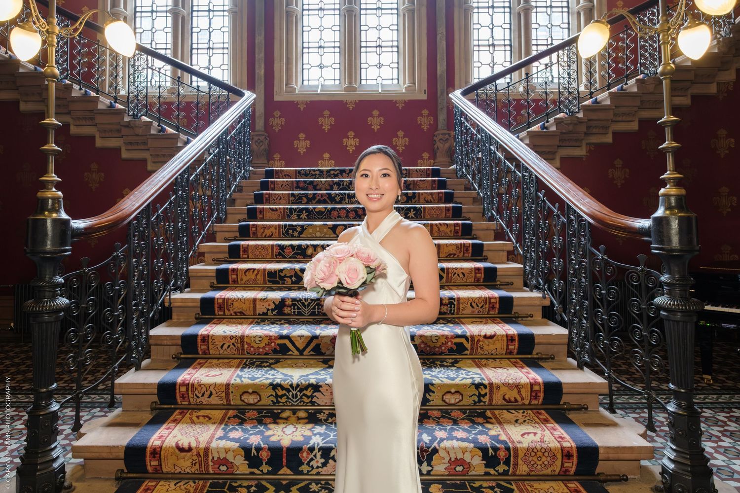 A sequence of black and white photos showing a person in formal attire posing on an ornate wooden staircase.