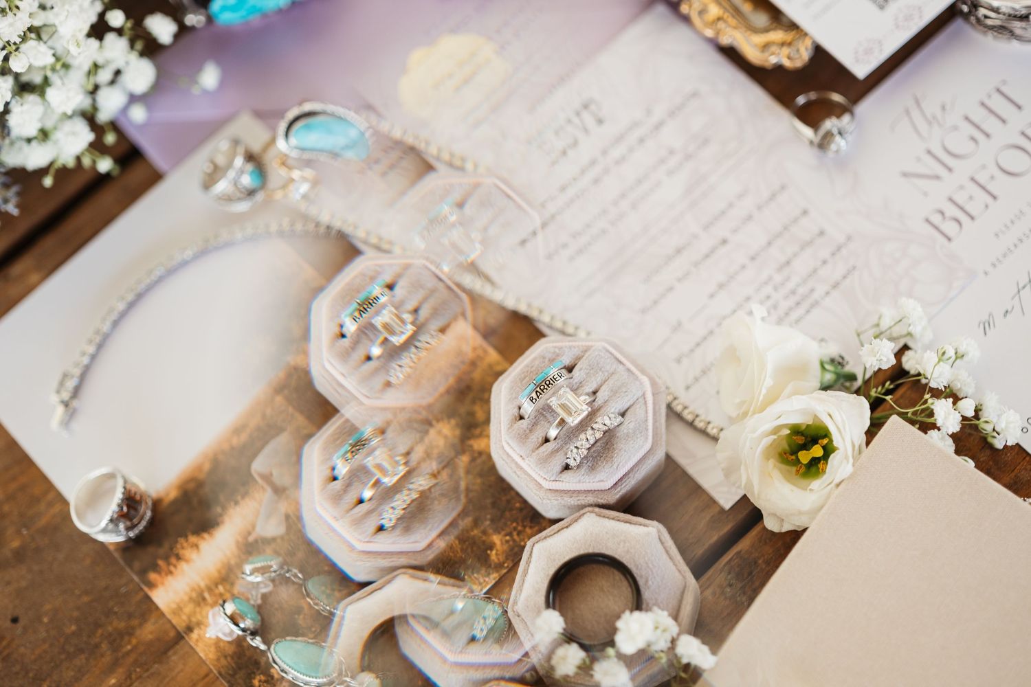 Elegant wedding table decorations feature white flowers, antique baubles, and vintage-style ornamental details on a rustic surface.